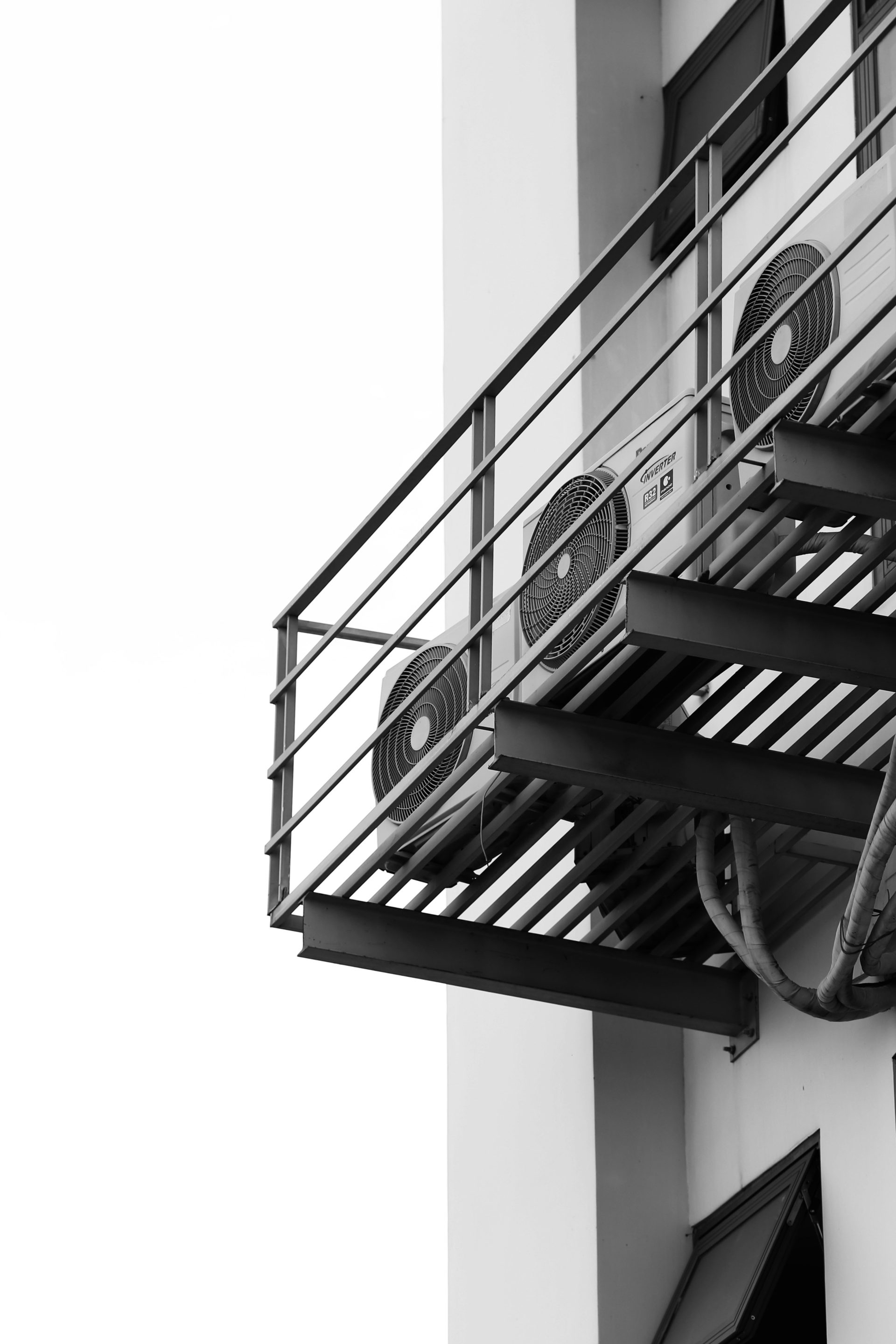 a black and white photo of a clock on a building